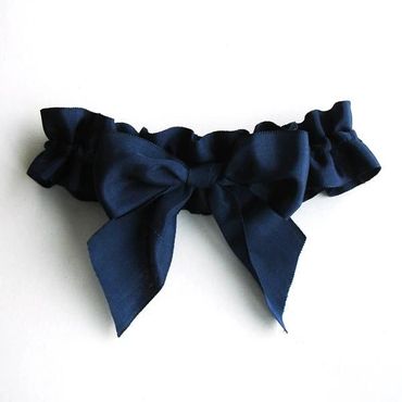 Elegant black garter with a large bow detail.