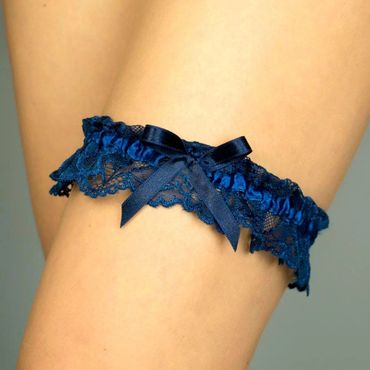Navy blue lace garter with a satin bow worn on thigh.