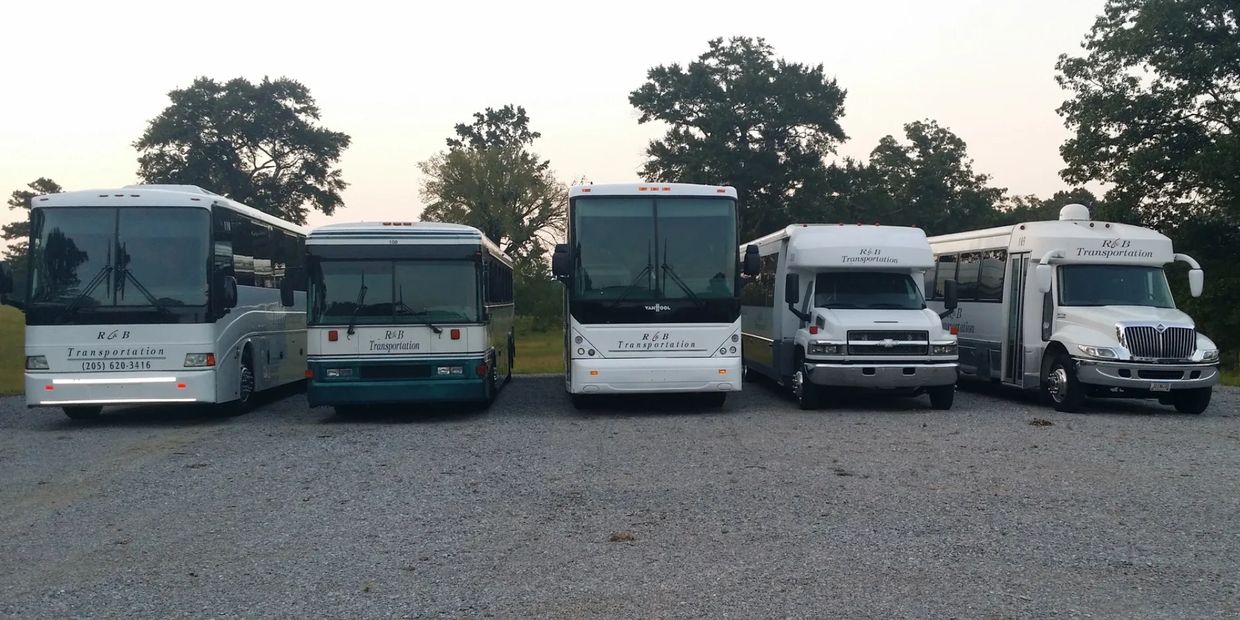 Fleet of five R&B Transportation buses parked outdoors.