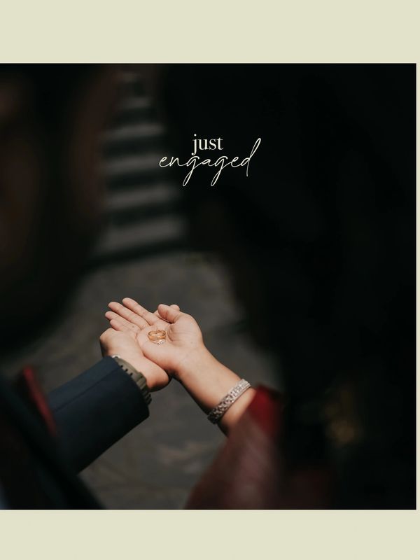 Couple holding wedding rings with "just engaged" text overlay.