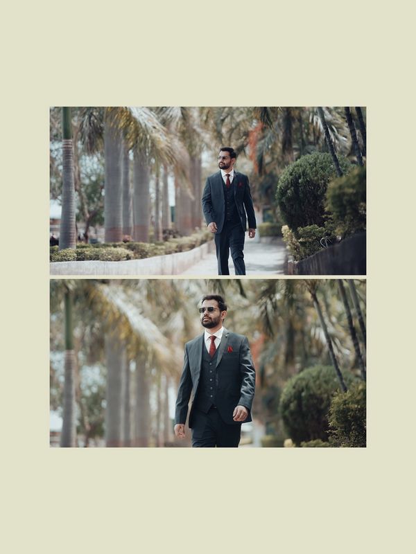 Man in a dark suit walking confidently along a palm-lined path. Photography Ranchi