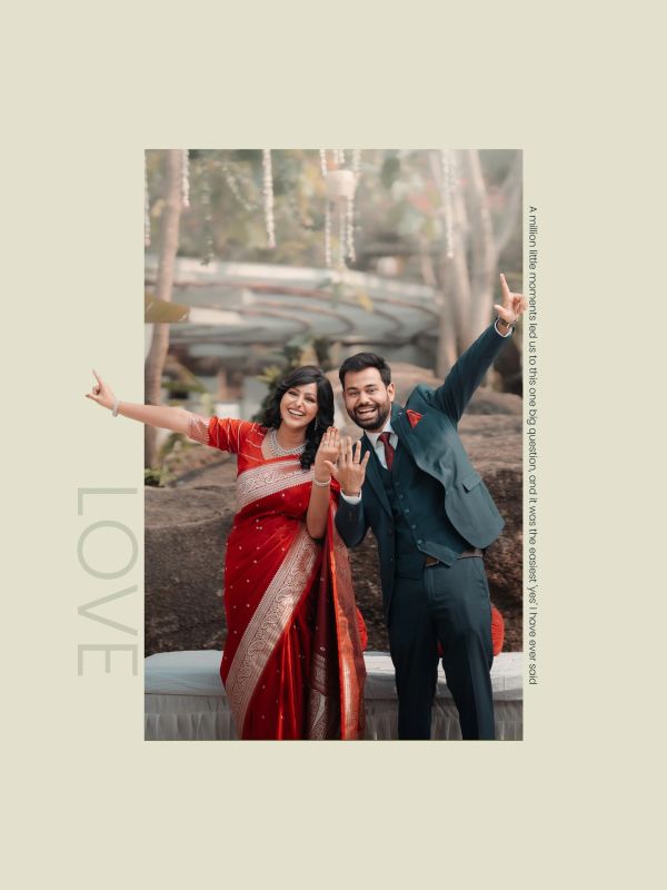 Happy couple in traditional attire showing their wedding rings joyfully.