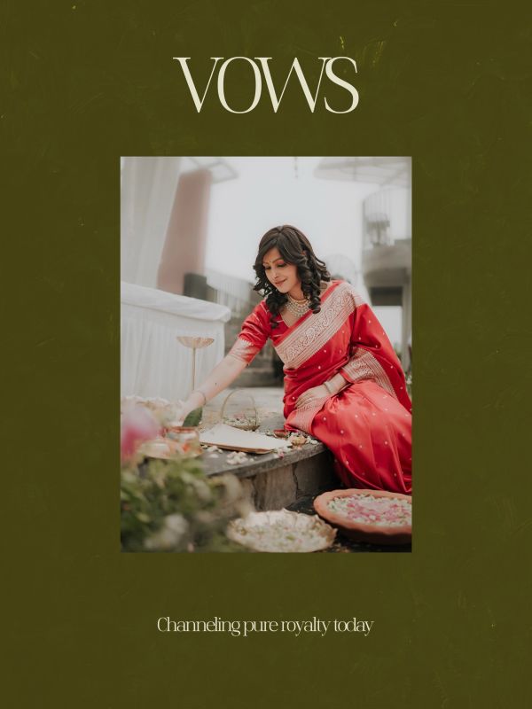 Woman in a red saree engaging in a traditional ritual with floral decorations.