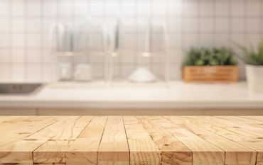 kitchen with wood cutting board and sink in background