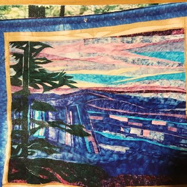 My hand pieced quilt displayed at a Walk in the Woods quilt show.