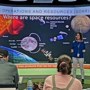 Woman presenting space resources in a classroom.