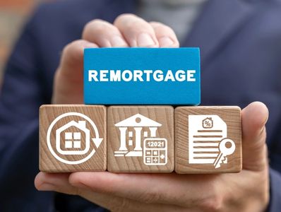 man holding cubes with the word remortgage