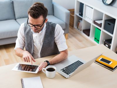 self employment - man working with digital tablet from home