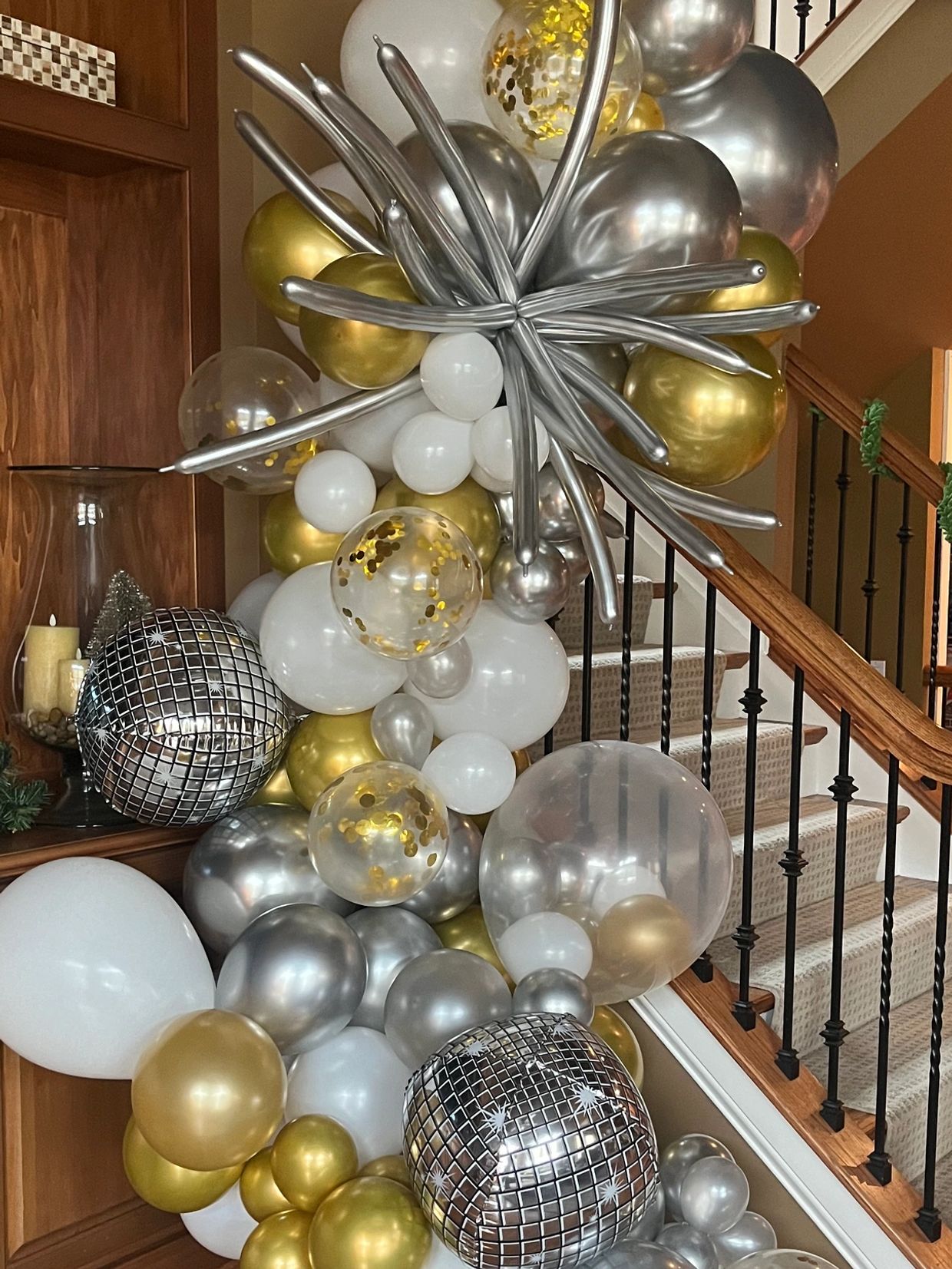 A balloon decoration in gold and white at the tv