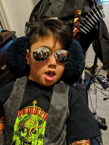 VOGM/VGM boy in wheelchair with aviator sunglasses on.