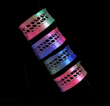 Colorful 3D-printed rings with hexagonal cutouts.