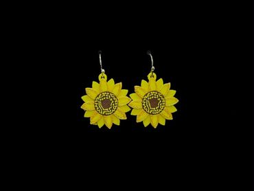 Pair of bright yellow sunflower earrings with detailed petals on black background.