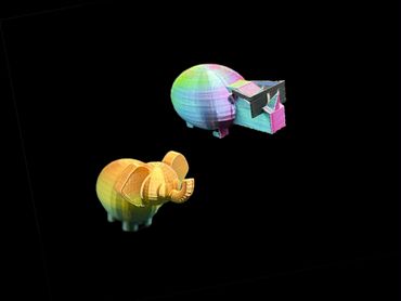 Two colorful 3D-printed animal figurines on black background.