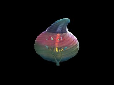 Colorful Halloween pumpkin with a carved face glowing in the dark.