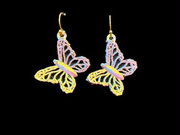Colorful butterfly-shaped earrings with intricate designs on a black background.