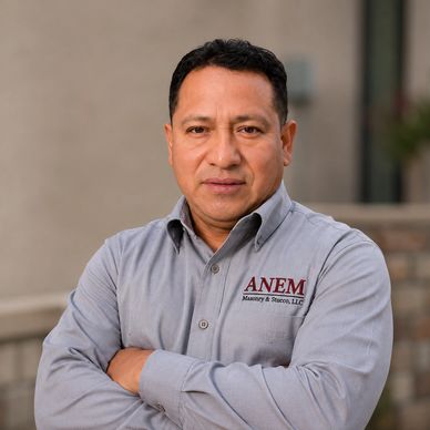 Man wearing a gray ANEM shirt with folded arms.