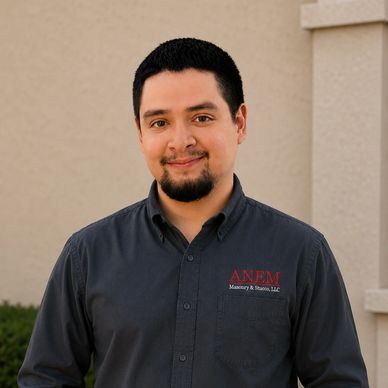 Man in a dark shirt smiling at the camera.