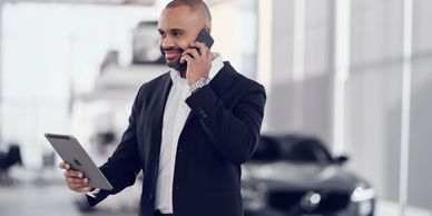 Professional using phone and tablet, symbolizing efficiency and technology in the consumer services