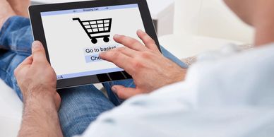 Person using a tablet for online shopping, symbolizing the convenience of e-commerce platforms.