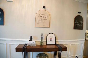 Decorative wall plaques and table setup in a modern interior.