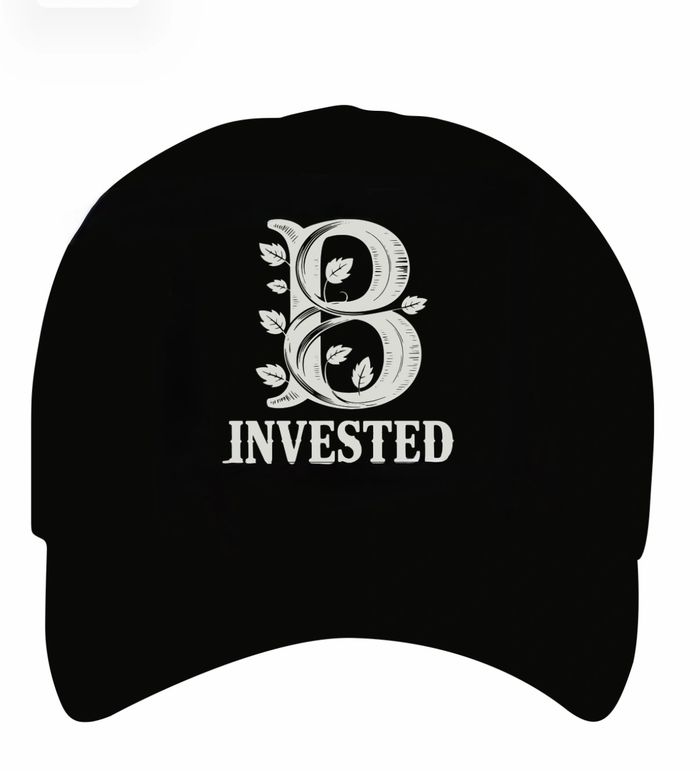 Black cap with decorative "B Invested" text and leaf design.