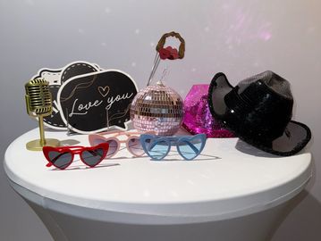 photo booth prop table with silly glasses hats and hand props