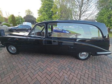 Driver side of black Daimler DS420 showing gloss and clean finish