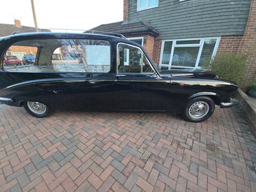Passenger side of black Daimler DS420 showing polish and tyre shine