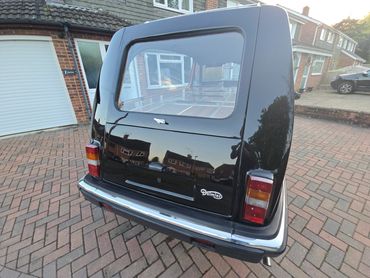 Rear of black Daimler DS420 with boot gloss and clean exhaust finish