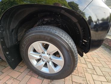 Wheel and caliper of black Toyota Land Cruiser cleaned by AM Auto Aesthetics
