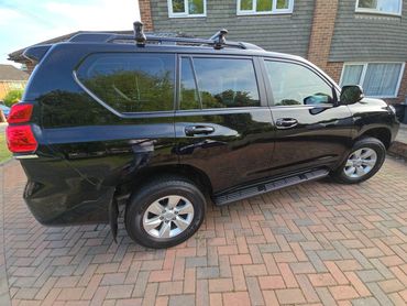 Driver side of black Toyota Land Cruiser showing gloss and clean finish