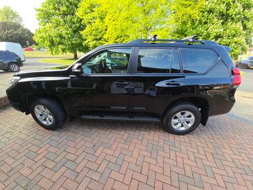 Passenger side of black Toyota Land Cruiser showing polish and tyre shine