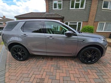 Driver side of grey Range Rover Discovery showing gloss and clean finish