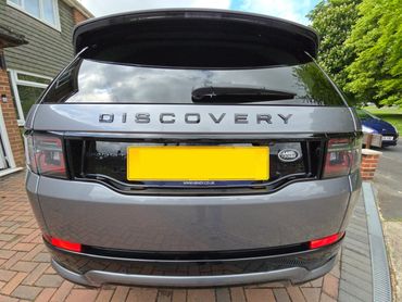 Rear of grey Range Rover Discovery with boot gloss and clean exhaust finish