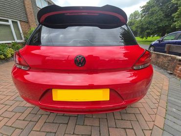 Rear of red Volkswagen Scirocco with boot gloss and clean exhaust finish