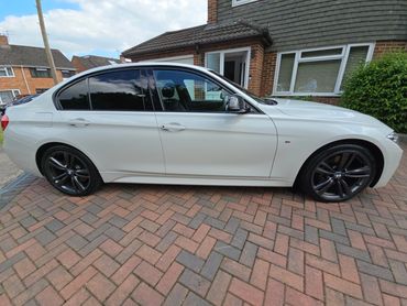 Driver side of white BMW 320 showing gloss and clean finish
