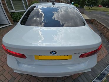 Rear of white BMW 320 with boot gloss