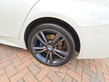 Wheel and caliper of white BMW 320 cleaned by AM Auto Aesthetics