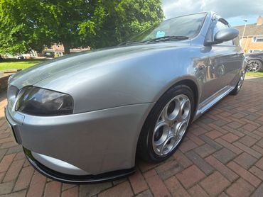 Front 3/4 of grey Alfa 147 with restored shine after valet by AM Auto Aesthetics