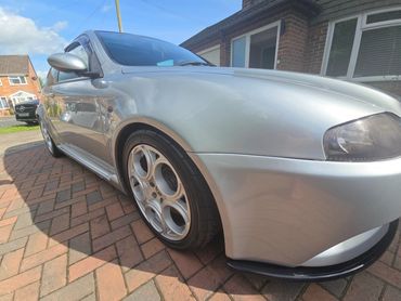 Front 3/4 of grey Alfa 147 with restored shine after valet by AM Auto Aesthetics
