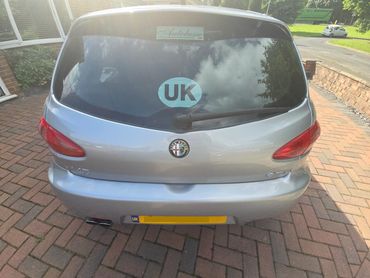 Rear of grey Alfa 147 with boot gloss and clean exhaust finish