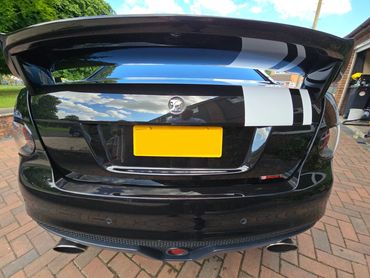 Rear of black Holden Bathurst with boot gloss and clean exhaust finish