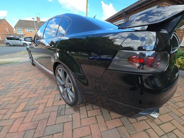 Rear 3/4 of black Holden Bathurst showing paintwork symmetry after detail