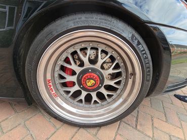 Wheel and caliper of black Porsche 911 Carrera S cleaned by AM Auto Aesthetics