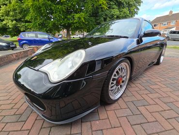 Front 3/4 of black Porsche 911 Carrera S polished to gloss by AM Auto Aesthetics
