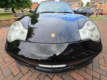 Front of black Porsche 911 Carrera S showing gloss after polish by AM Auto Aesthetics