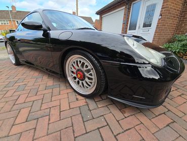 Front 3/4 of black Porsche 911 Carrera S polished to gloss by AM Auto Aesthetics