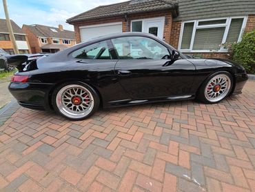 Driver side of black Porsche 911 Carrera S showing gloss and clean finish