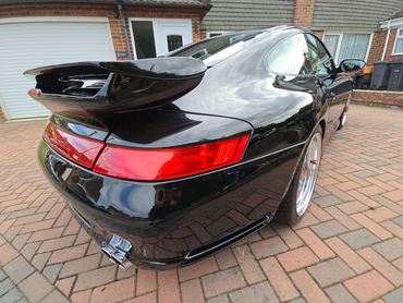 Rear 3/4 of black Porsche 911 Carrera S polished and detailed by AM Auto Aesthetics