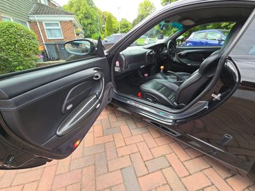 Porsche passenger door open showing clean door and interior